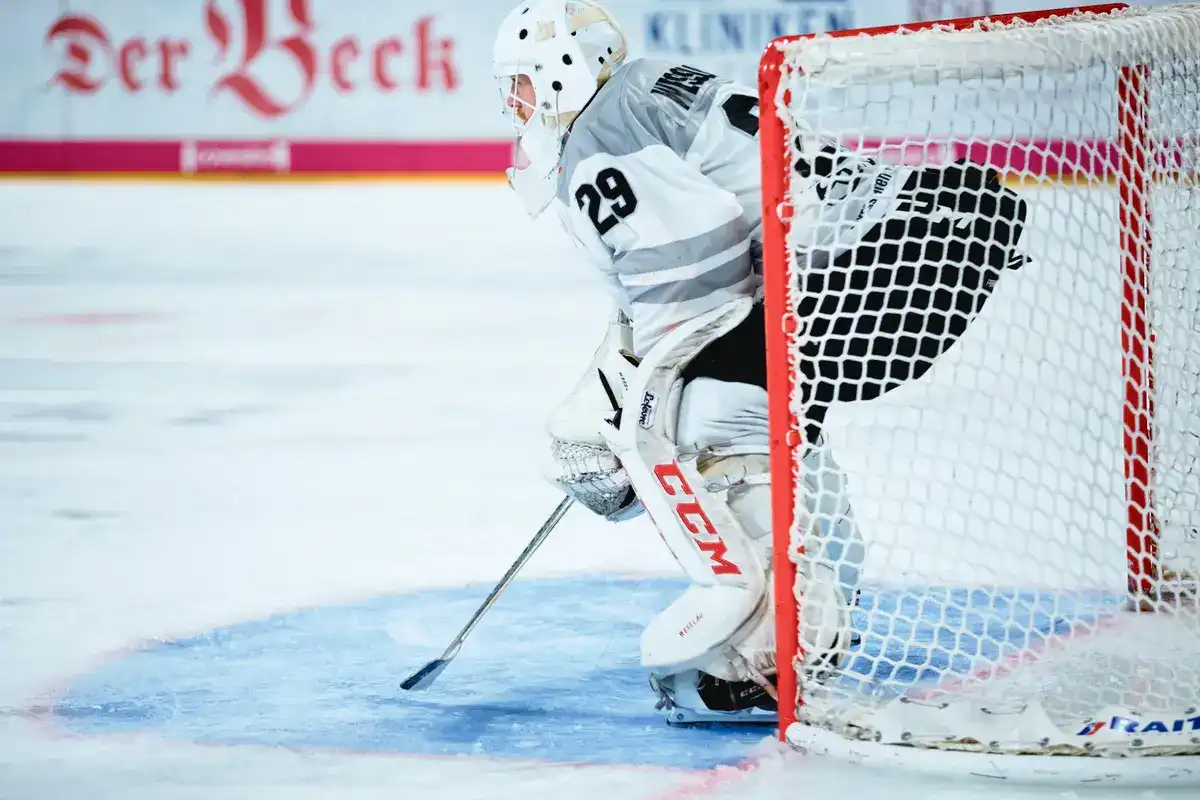 Hockey goalie crouching and focused during a game